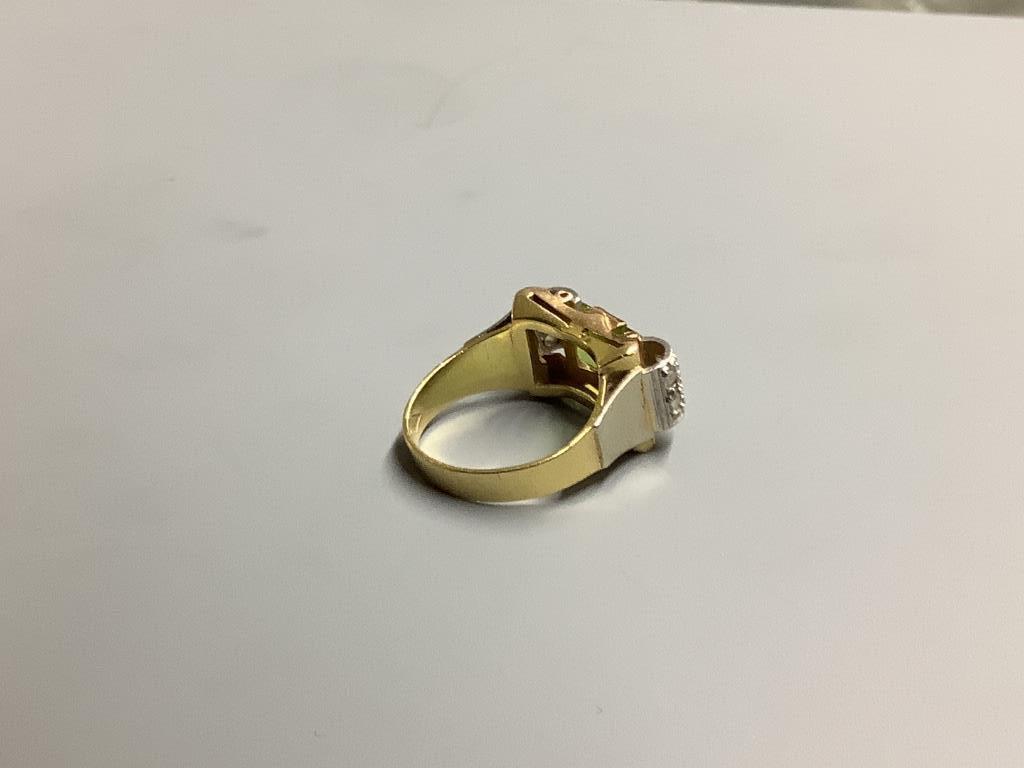 A 1950's? 750 yellow metal, peridot and diamond set dress ring, size O, gross 6.9 grams.